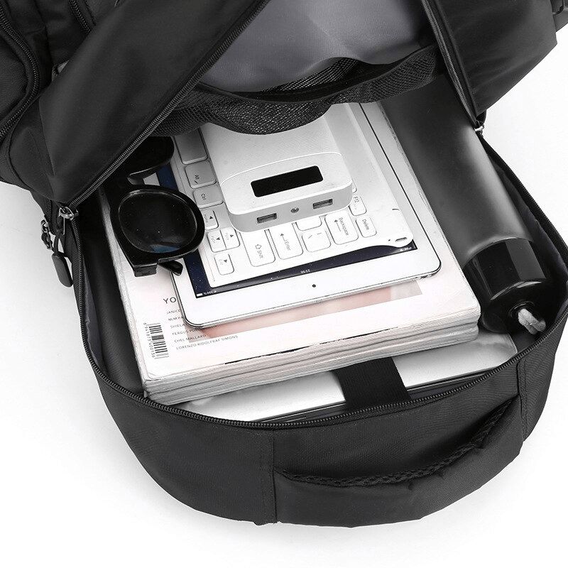 Open sports backpack displaying interior computer interlayer with gadgets, water bottle, and sunglasses neatly packed.